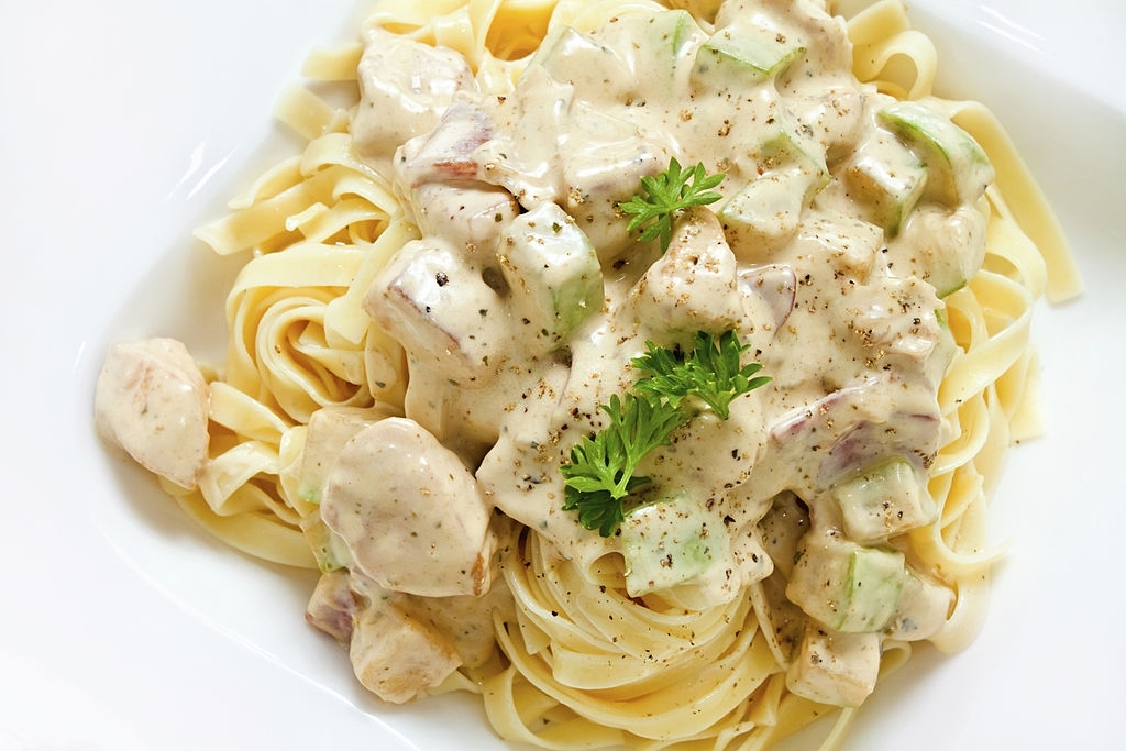 Fettuccine Alfredo with white chicken zucchini sauce with nice copy space. Overhead shot